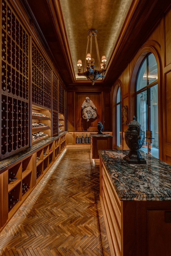 This is an example of a transitional wine cellar in Houston with medium hardwood floors, display racks and brown floor.