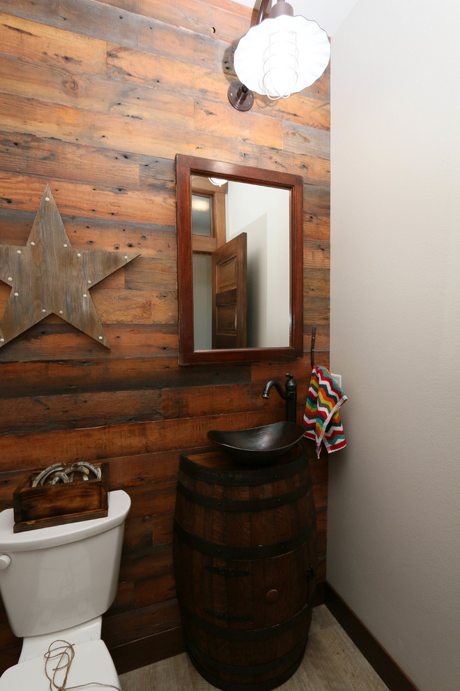 Photo of a mid-sized eclectic powder room in Other with brown cabinets, ceramic tile and an undermount sink.