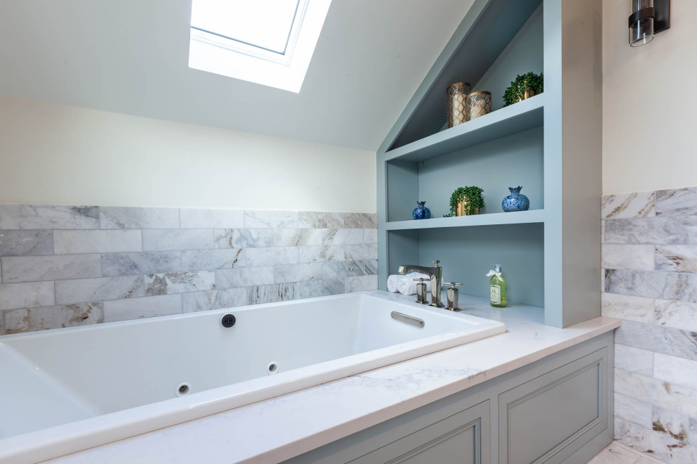 This is an example of a large traditional master bathroom in Chicago with beaded inset cabinets, blue cabinets, an alcove tub, a corner shower, a two-piece toilet, white walls, porcelain floors, an undermount sink, engineered quartz benchtops, white floor, a hinged shower door and white benchtops.