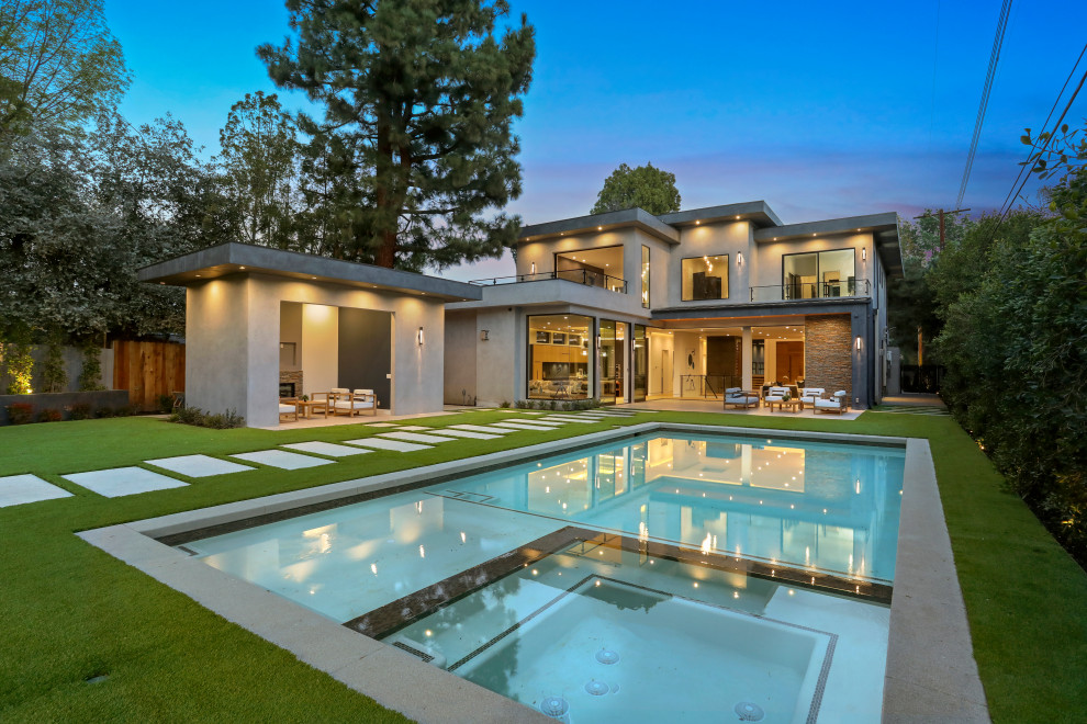 Inspiration for a large contemporary backyard rectangular pool in Los Angeles with a hot tub and concrete slab.