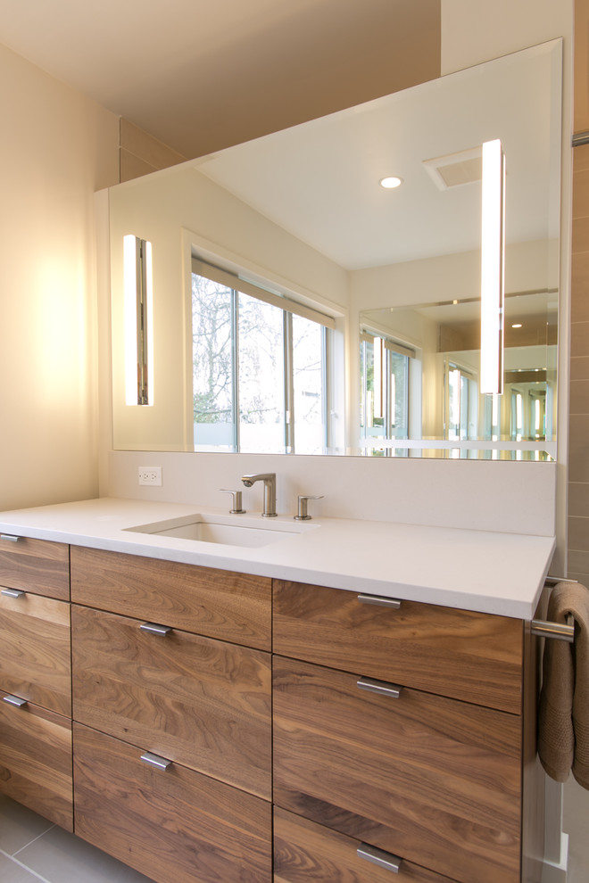 Inspiration for a large contemporary master bathroom in Seattle with flat-panel cabinets, medium wood cabinets, a curbless shower, beige walls, ceramic floors, a drop-in sink, grey floor, an open shower and white benchtops.
