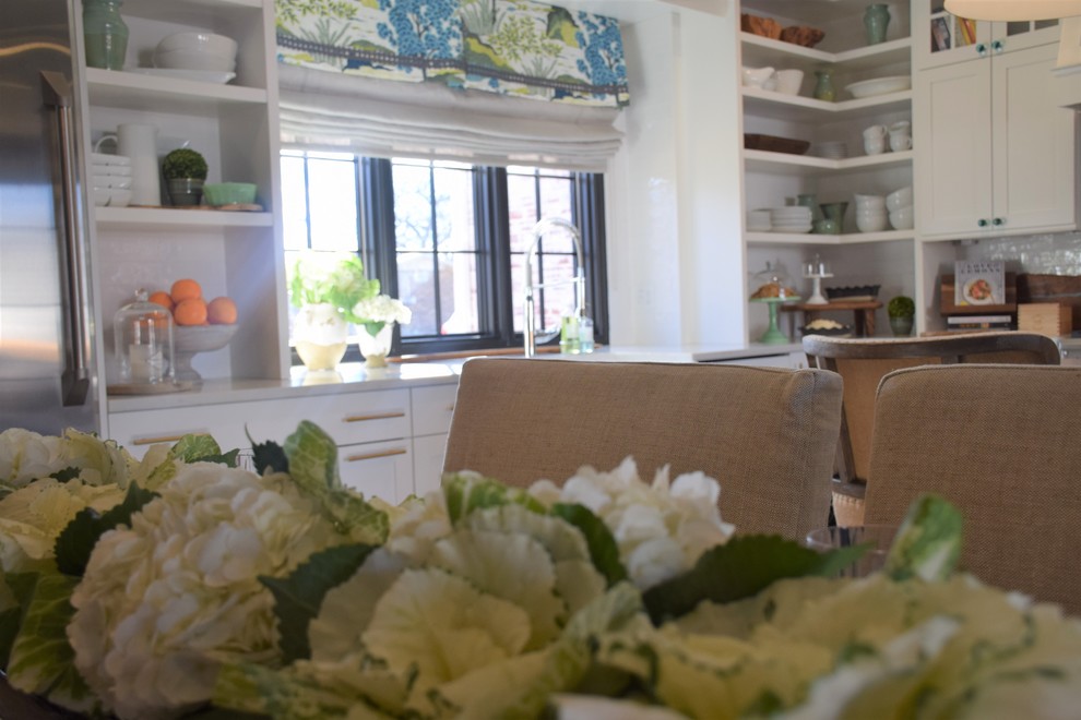 Eat-in kitchen - large transitional dark wood floor eat-in kitchen idea with a farmhouse sink, shaker cabinets, white cabinets, quartzite countertops, white backsplash, subway tile backsplash, stainless steel appliances and an island