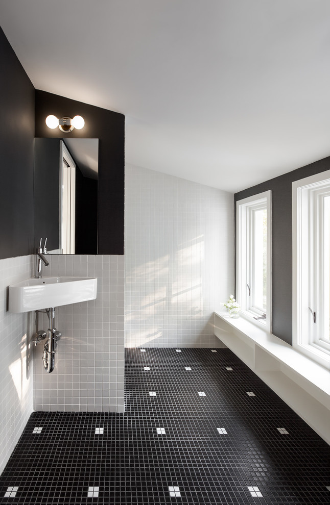 Photo of a contemporary bathroom in Boston with open cabinets, white cabinets, black and white tile, black walls, ceramic floors and a wall-mount sink.