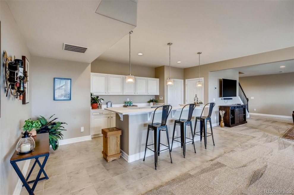 Example of a transitional home design design in Denver