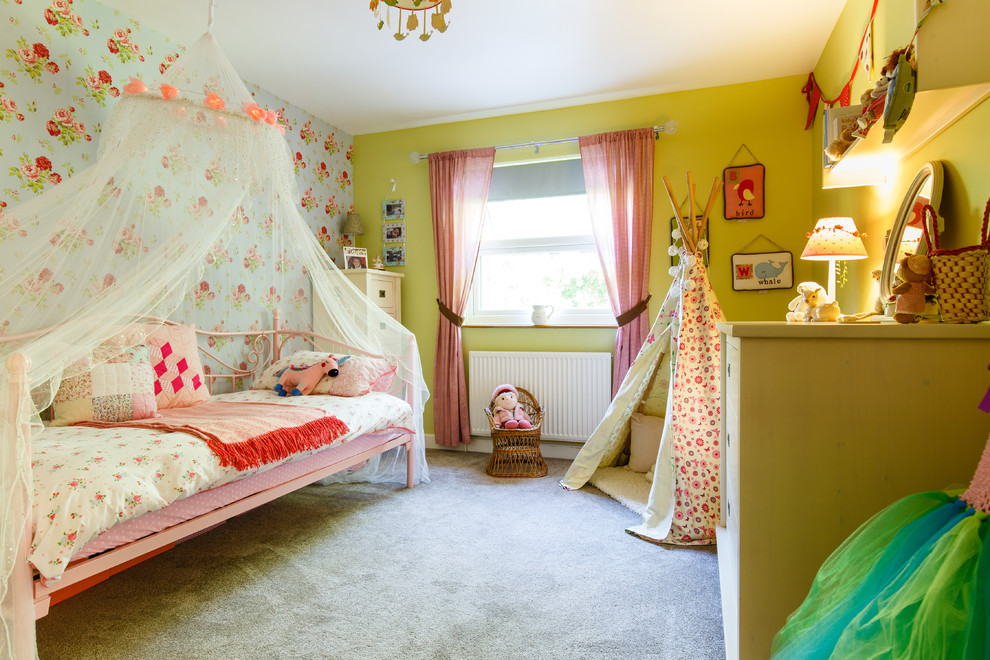 Photo of a mid-sized transitional kids' bedroom for kids 4-10 years old and girls in Cambridgeshire with green walls, carpet and grey floor.