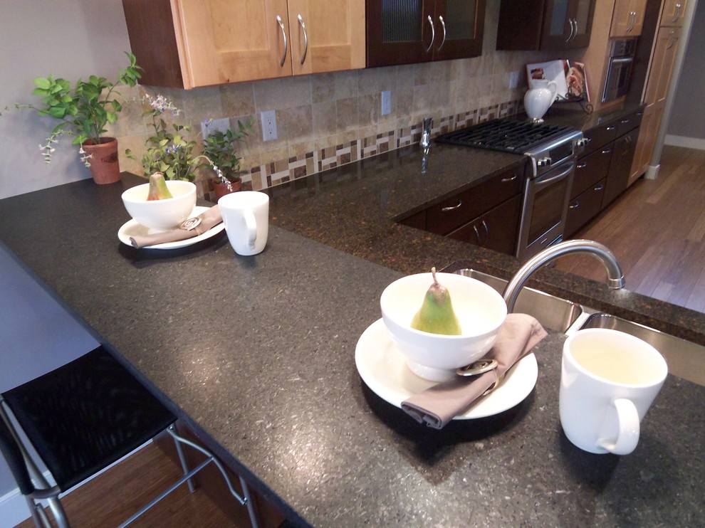 Eat-in kitchen - mid-sized transitional galley bamboo floor eat-in kitchen idea with an undermount sink, shaker cabinets, dark wood cabinets, quartz countertops, beige backsplash, ceramic backsplash, stainless steel appliances and a peninsula