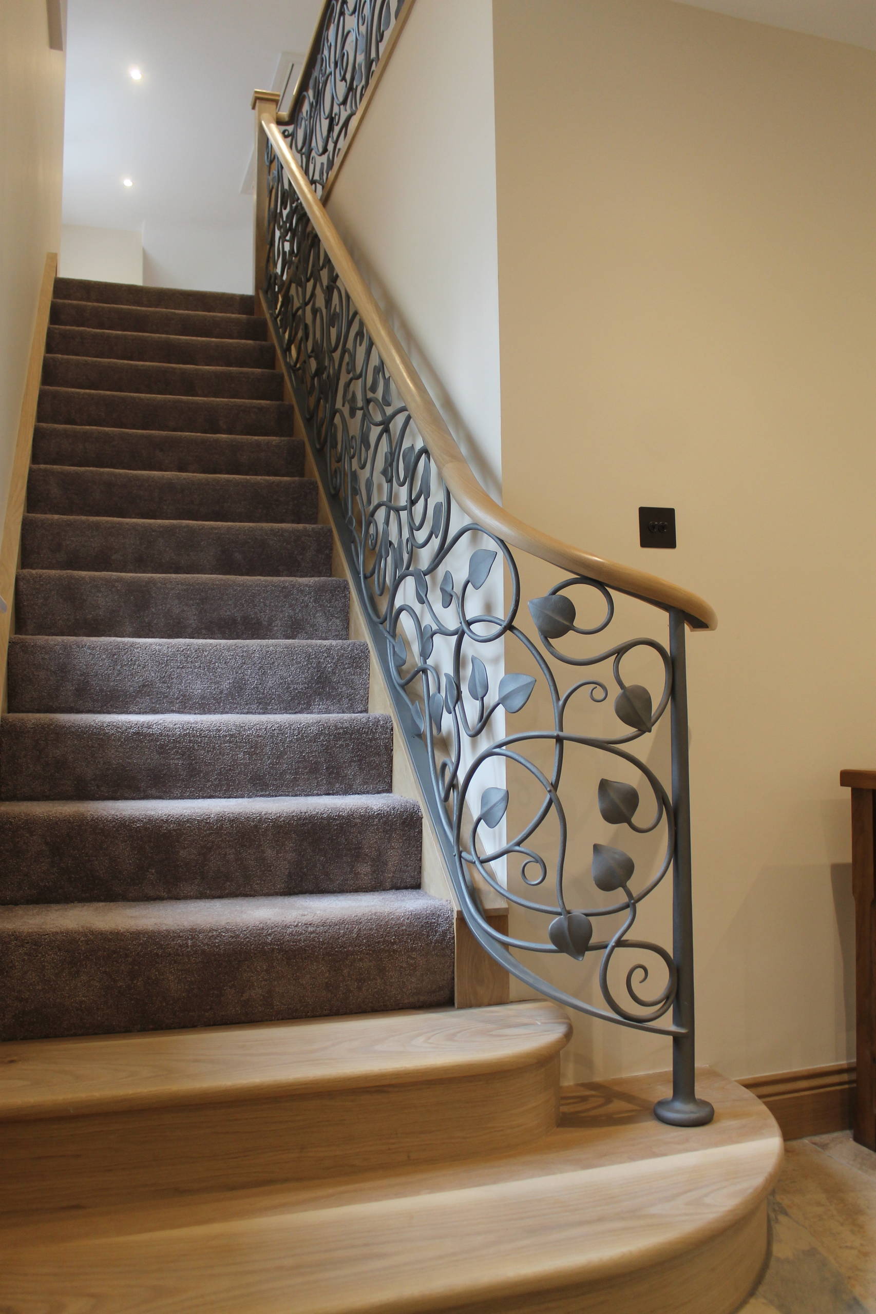 Curved handrail with foliage metal work