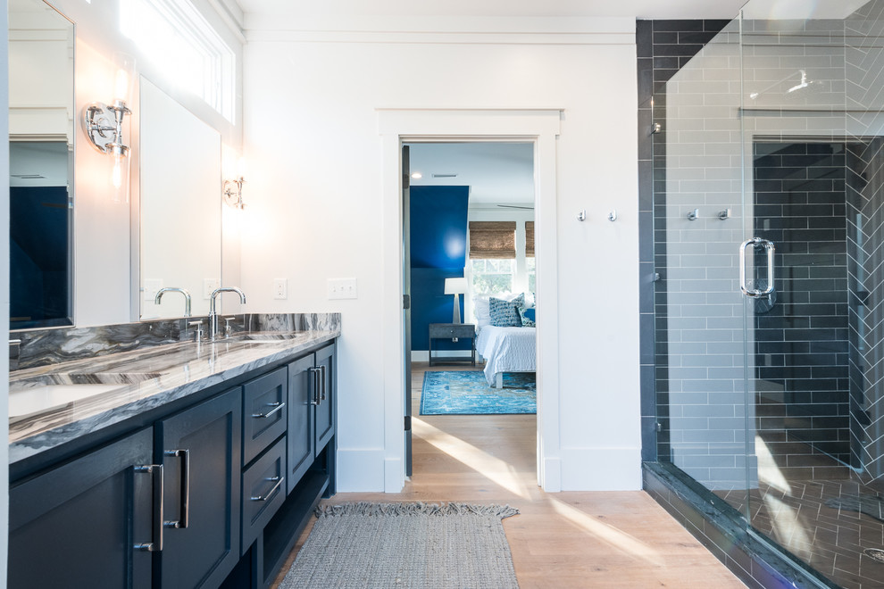 Photo of a large modern 3/4 bathroom in Charleston with shaker cabinets, black cabinets, an alcove tub, a shower/bathtub combo, a two-piece toilet, subway tile, white walls, cement tiles, an undermount sink, marble benchtops, multi-coloured floor, a shower curtain and black tile.