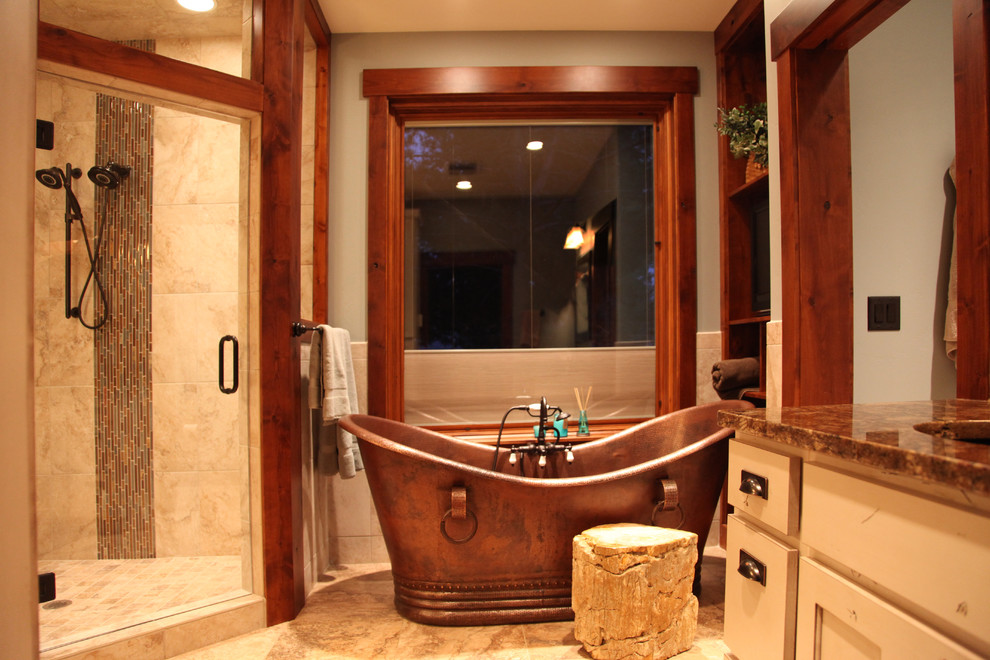 Inspiration for a large rustic master beige floor freestanding bathtub remodel with recessed-panel cabinets, light wood cabinets, beige walls, an undermount sink, granite countertops and a hinged shower door