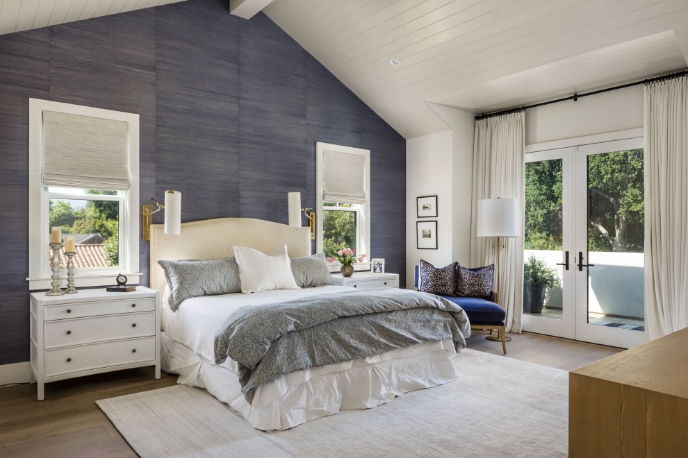 Example of a large transitional master medium tone wood floor, gray floor, vaulted ceiling and wallpaper bedroom design in San Francisco with blue walls