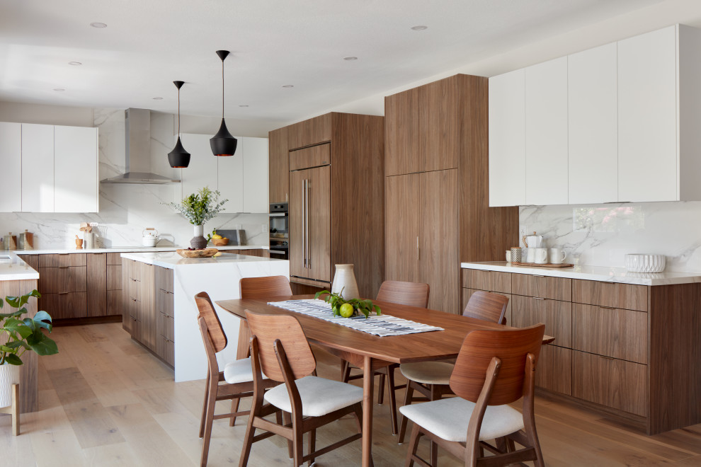 Eat-in kitchen - modern u-shaped medium tone wood floor and brown floor eat-in kitchen idea in San Francisco with flat-panel cabinets, medium tone wood cabinets, white backsplash, stone slab backsplash, paneled appliances, an island and white countertops