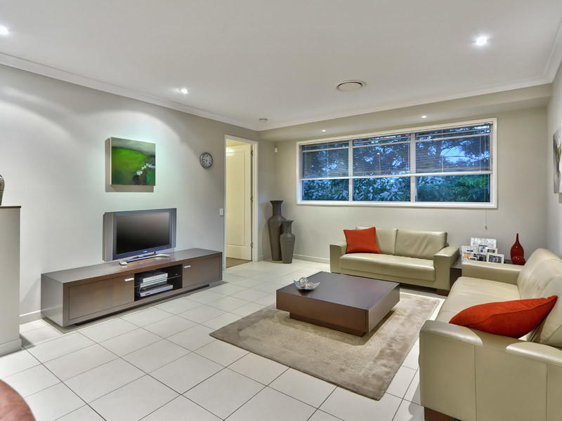 Photo of an expansive contemporary open concept living room in Brisbane with grey walls, ceramic floors, a freestanding tv and grey floor.