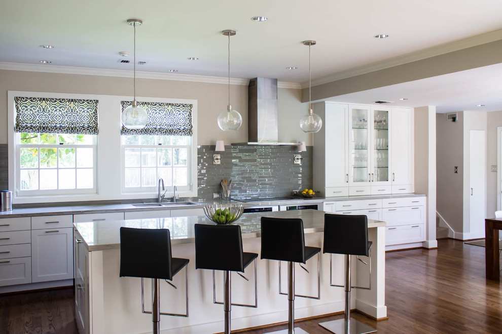 Large transitional l-shaped dark wood floor open concept kitchen photo in Houston with a double-bowl sink, shaker cabinets, white cabinets, quartzite countertops, gray backsplash, glass tile backsplash, stainless steel appliances and an island