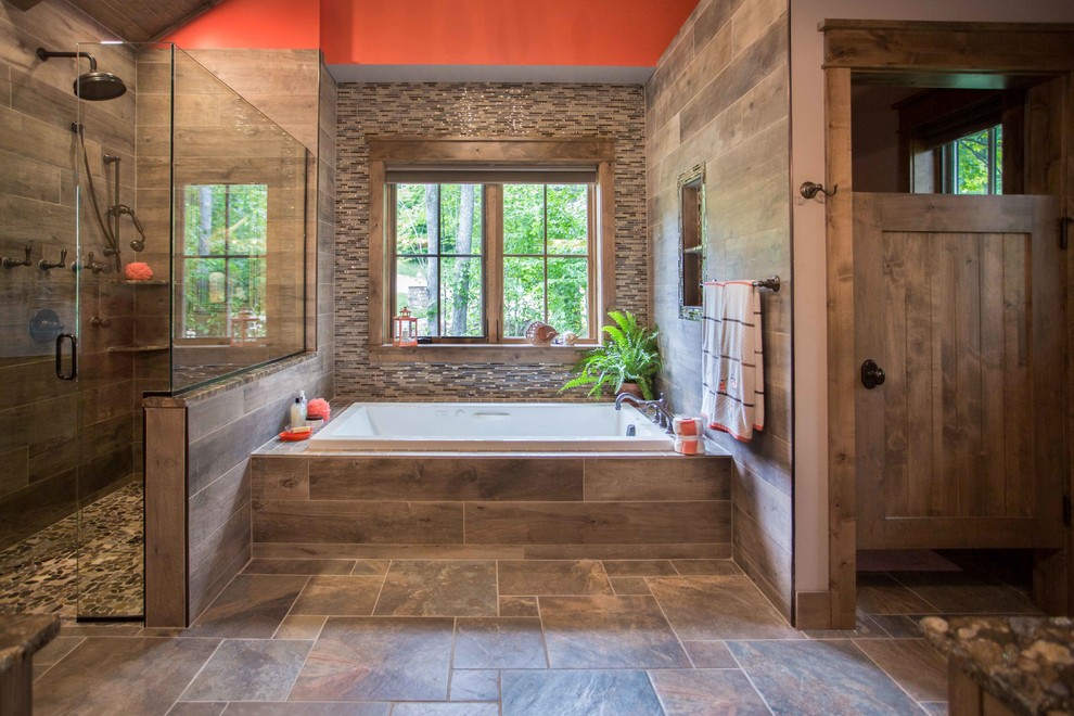 Mid-sized country master bathroom in Other with a drop-in tub, a corner shower, multi-coloured tile, matchstick tile, grey walls, ceramic floors, brown floor and a hinged shower door.