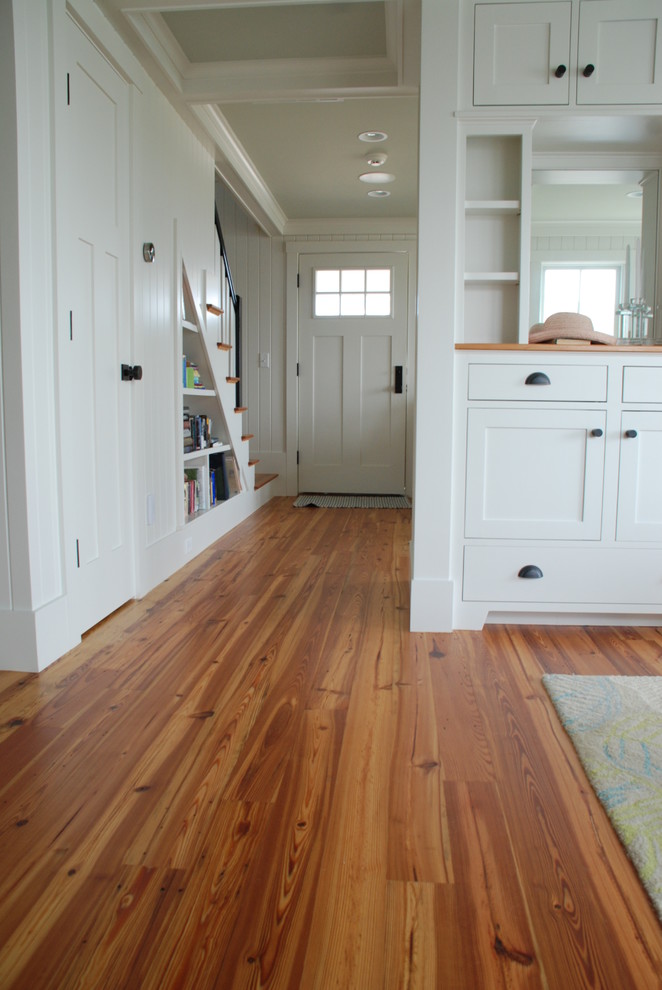 This is an example of a mid-sized arts and crafts hallway in Boston with white walls and medium hardwood floors.