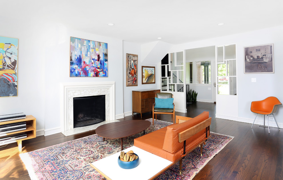 Photo of a mid-sized midcentury open concept living room in Chicago with white walls, medium hardwood floors, a standard fireplace, a plaster fireplace surround and no tv.