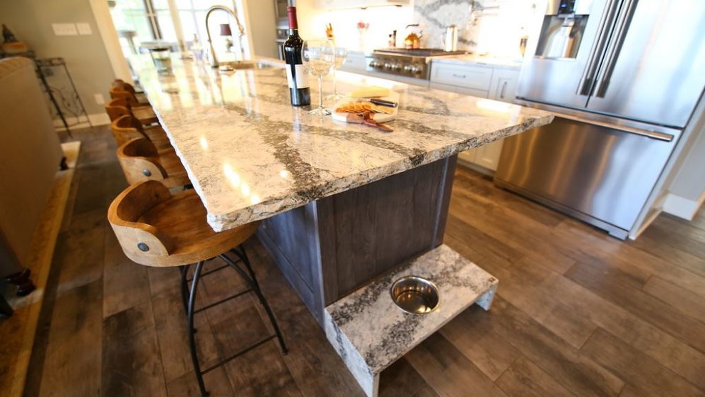 Open concept kitchen - modern galley open concept kitchen idea in Grand Rapids with a double-bowl sink, shaker cabinets, gray cabinets, quartz countertops, stainless steel appliances and an island
