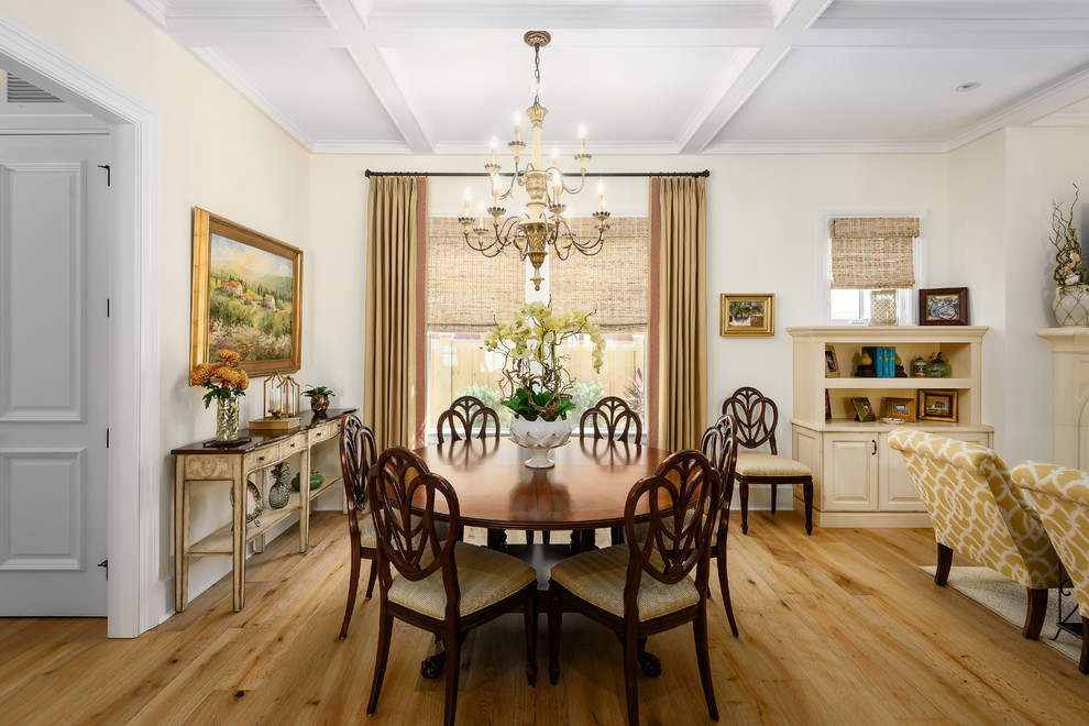 Mid-sized mediterranean open plan dining in Jacksonville with white walls, light hardwood floors and beige floor.