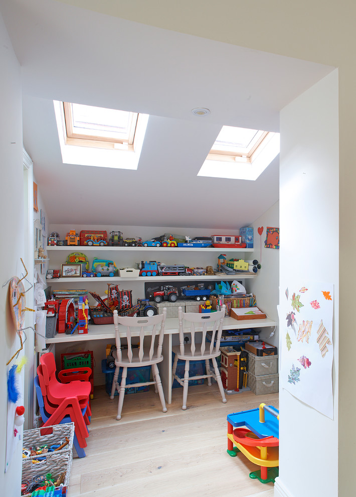 Inspiration for a contemporary gender-neutral kids' study room for kids 4-10 years old in Dublin with white walls and light hardwood floors.