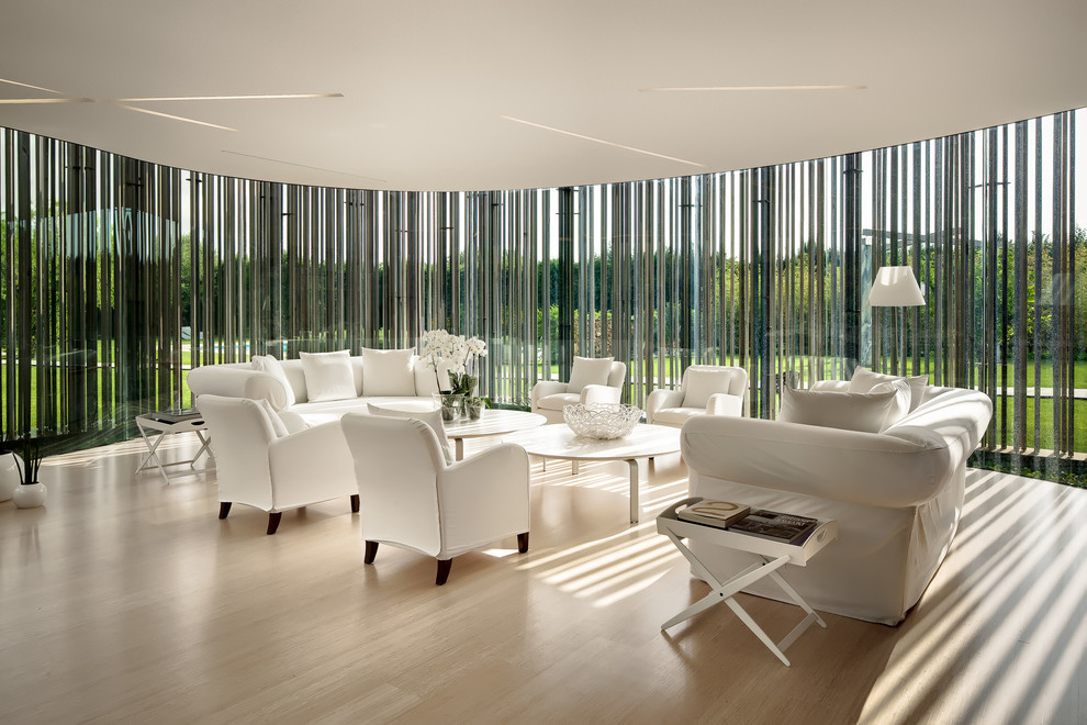 This is an example of a large contemporary sunroom in Turin with light hardwood floors.