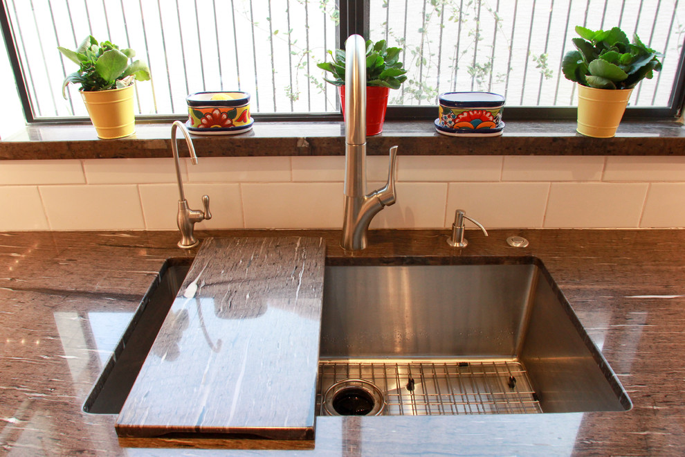 Mid-sized transitional u-shaped porcelain tile and brown floor eat-in kitchen photo in Phoenix with an undermount sink, shaker cabinets, white cabinets, white backsplash, subway tile backsplash, stainless steel appliances, an island, granite countertops and brown countertops