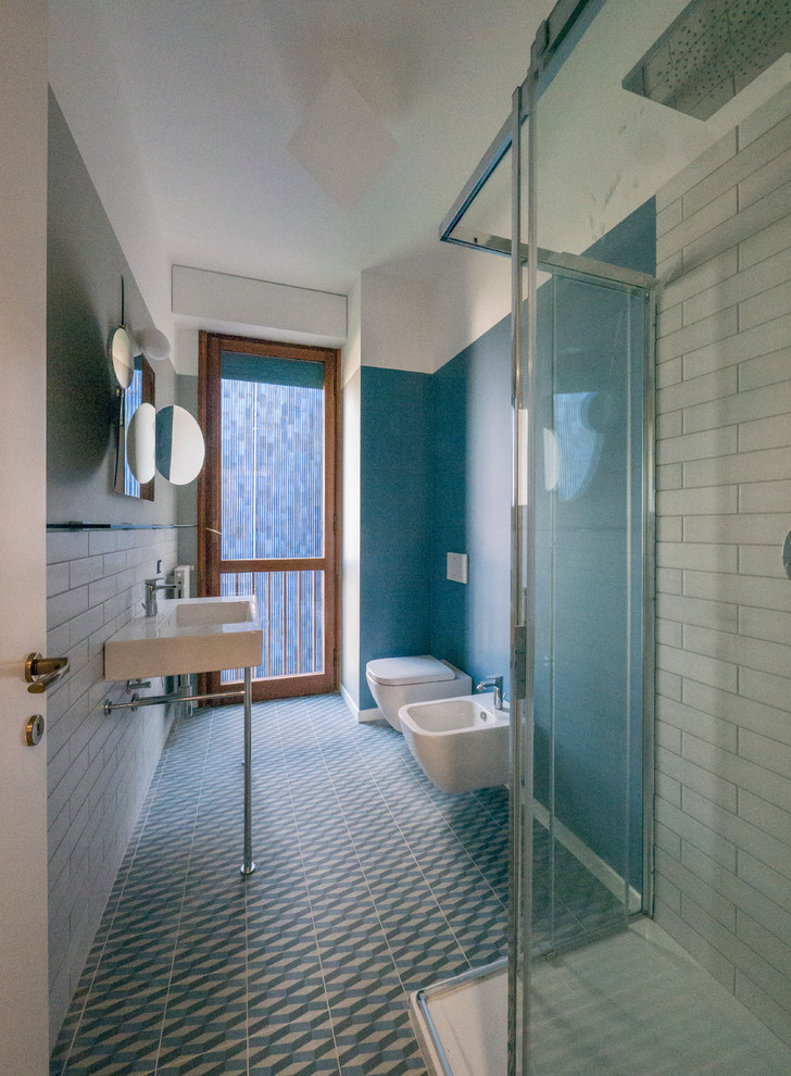Photo of a mid-sized modern master bathroom in Milan with flat-panel cabinets, beige cabinets, a drop-in tub, a shower/bathtub combo, a two-piece toilet, multi-coloured tile, porcelain tile, beige walls, a vessel sink and marble benchtops.