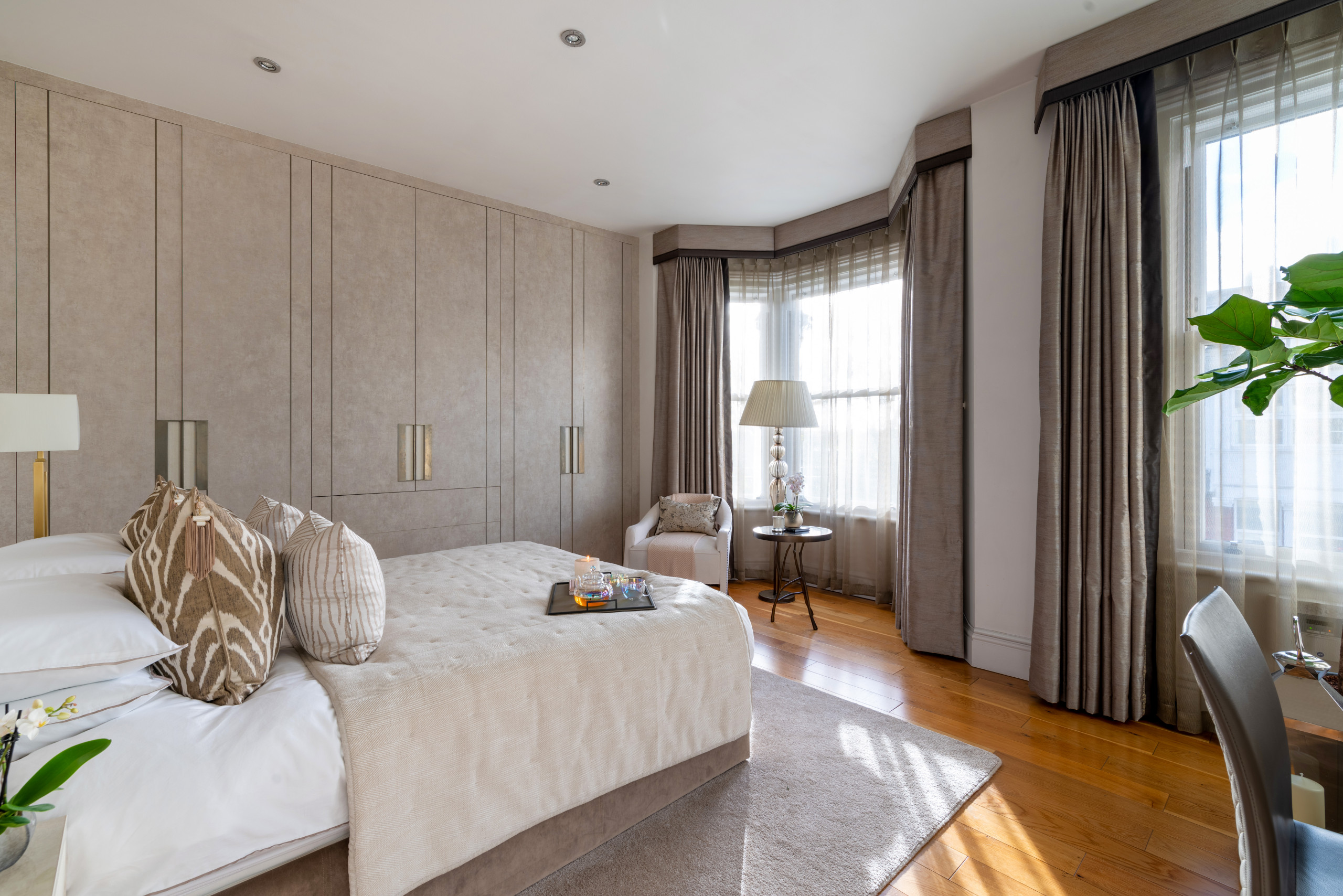 The brief was to uplift this previous dark wood wine display lounge & convert it into a bedroom with light pallette.  Light and airy colours in fabrics & finishes were introduced, and careful use of m