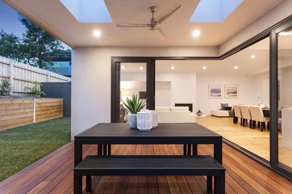 Mid-sized contemporary backyard deck in Melbourne with a roof extension.
