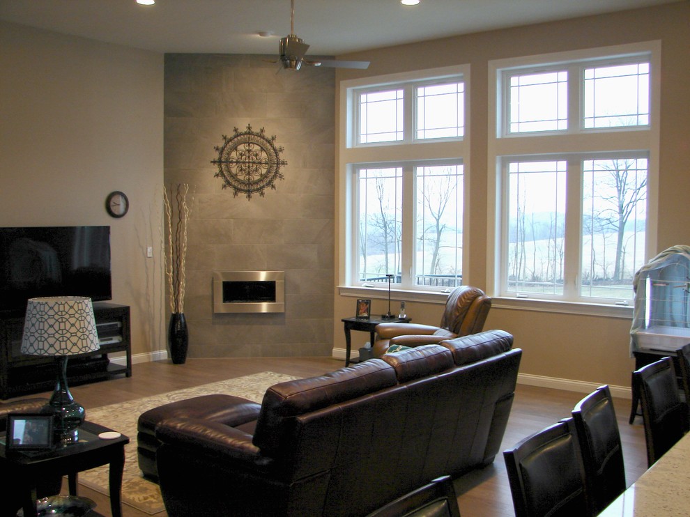 Photo of a mid-sized transitional open concept family room in Philadelphia with beige walls, medium hardwood floors, a ribbon fireplace, a metal fireplace surround and a freestanding tv.
