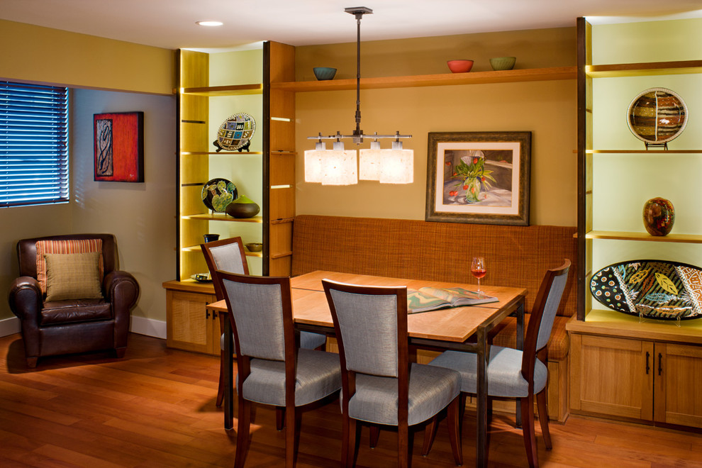 This is an example of a contemporary dining room in Austin with beige walls and medium hardwood floors.