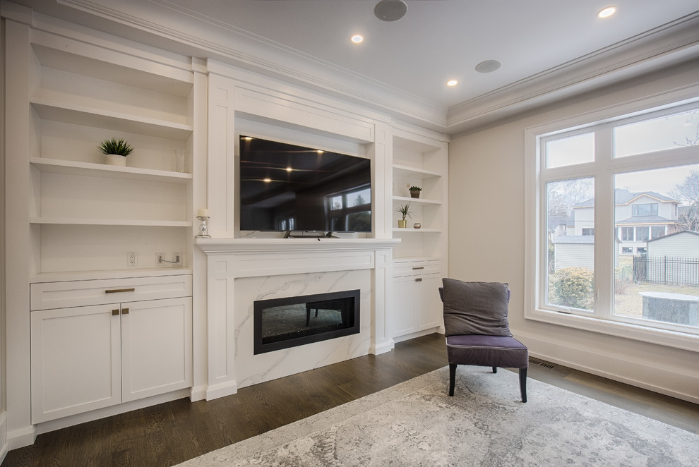 Mid-sized contemporary formal enclosed living room in Toronto with beige walls, dark hardwood floors, a standard fireplace, a stone fireplace surround, a wall-mounted tv and brown floor.