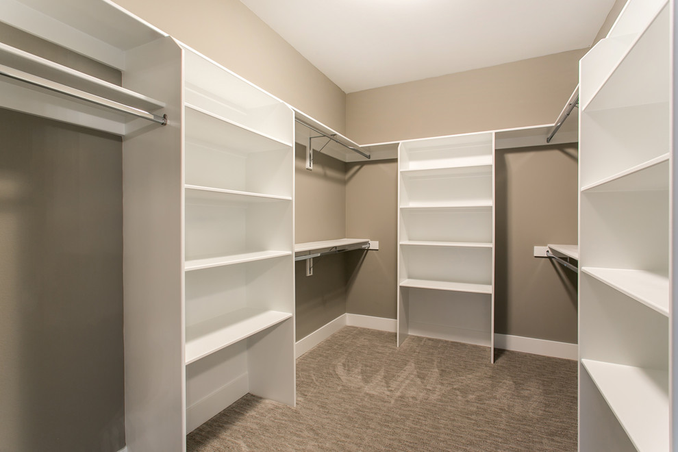 Inspiration for a mid-sized transitional gender-neutral walk-in wardrobe in Seattle with open cabinets, white cabinets, carpet and grey floor.