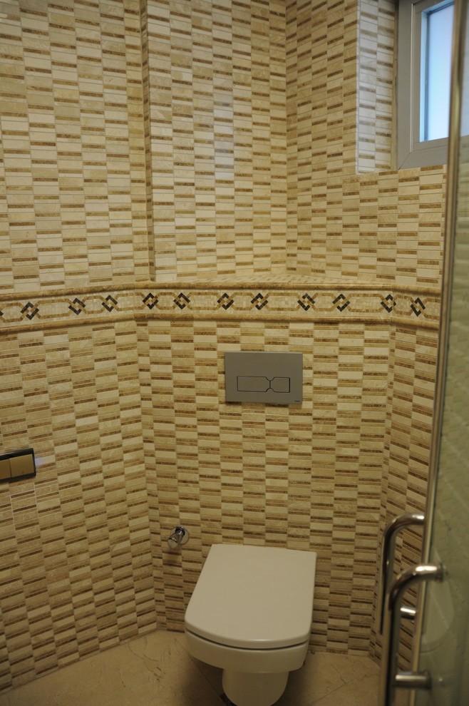 Photo of a mediterranean cloakroom in Atlanta with beige tiles.