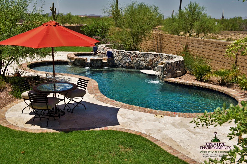 Large backyard stamped concrete and custom-shaped hot tub photo in Phoenix