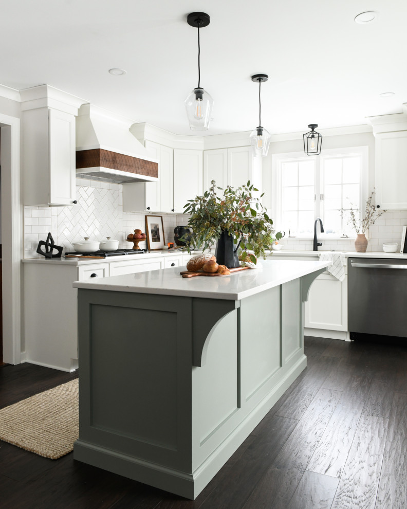 Example of a large transitional brown floor eat-in kitchen design with an undermount sink, white cabinets, quartz countertops, white backsplash, subway tile backsplash, stainless steel appliances, an island and white countertops