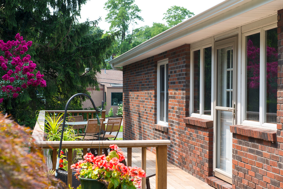 Inspiration for a small transitional backyard deck remodel with no cover
