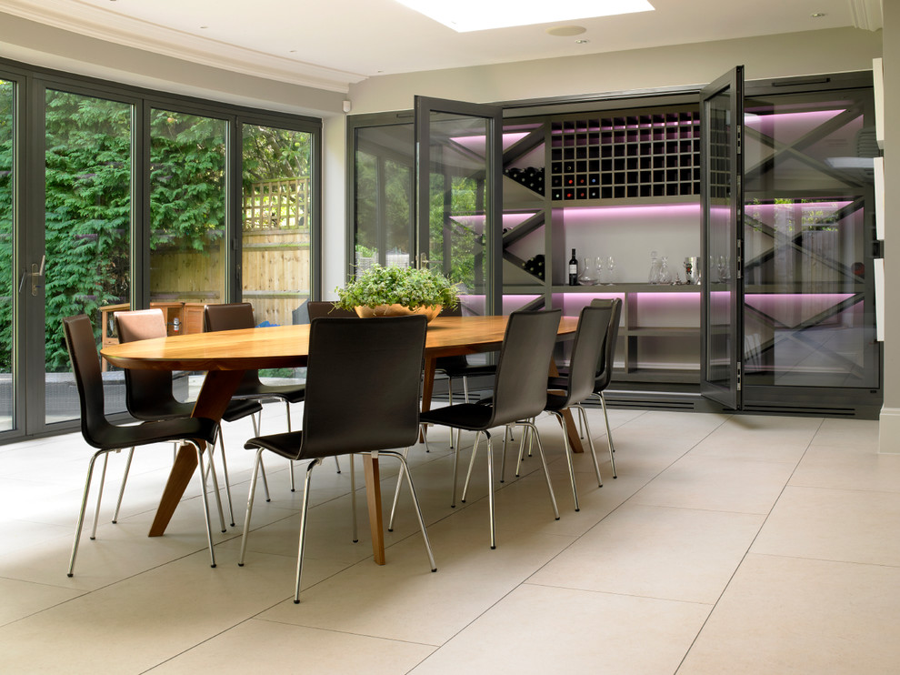 Contemporary wine cellar in London with storage racks and beige floor.