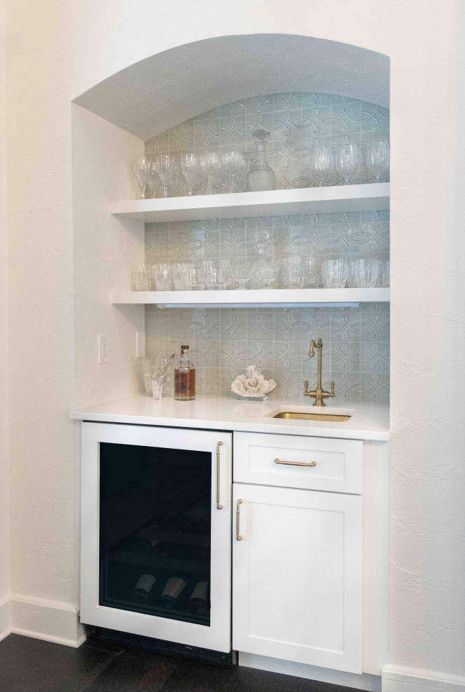 Photo of a small nautical single-wall wet bar in Jacksonville with a submerged sink, flat-panel cabinets, white cabinets, quartz worktops, green splashback, brown floors and white worktops.