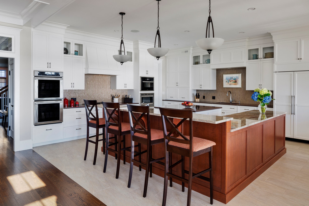 Example of a large transitional l-shaped porcelain tile enclosed kitchen design in Boston with a single-bowl sink, raised-panel cabinets, white cabinets, granite countertops, metallic backsplash, glass tile backsplash, paneled appliances and two islands