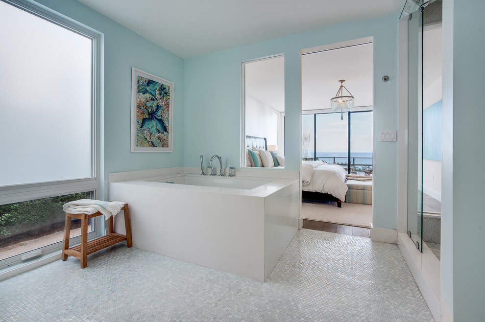Beach style master wet room bathroom in Los Angeles with flat-panel cabinets, light wood cabinets, glass sheet wall, blue walls, a drop-in sink, engineered quartz benchtops, an undermount tub and white tile.
