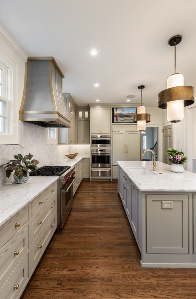 Mid-sized trendy l-shaped medium tone wood floor and brown floor enclosed kitchen photo with an undermount sink, flat-panel cabinets, gray cabinets, quartz countertops, white backsplash, quartz backsplash, paneled appliances, an island and white countertops