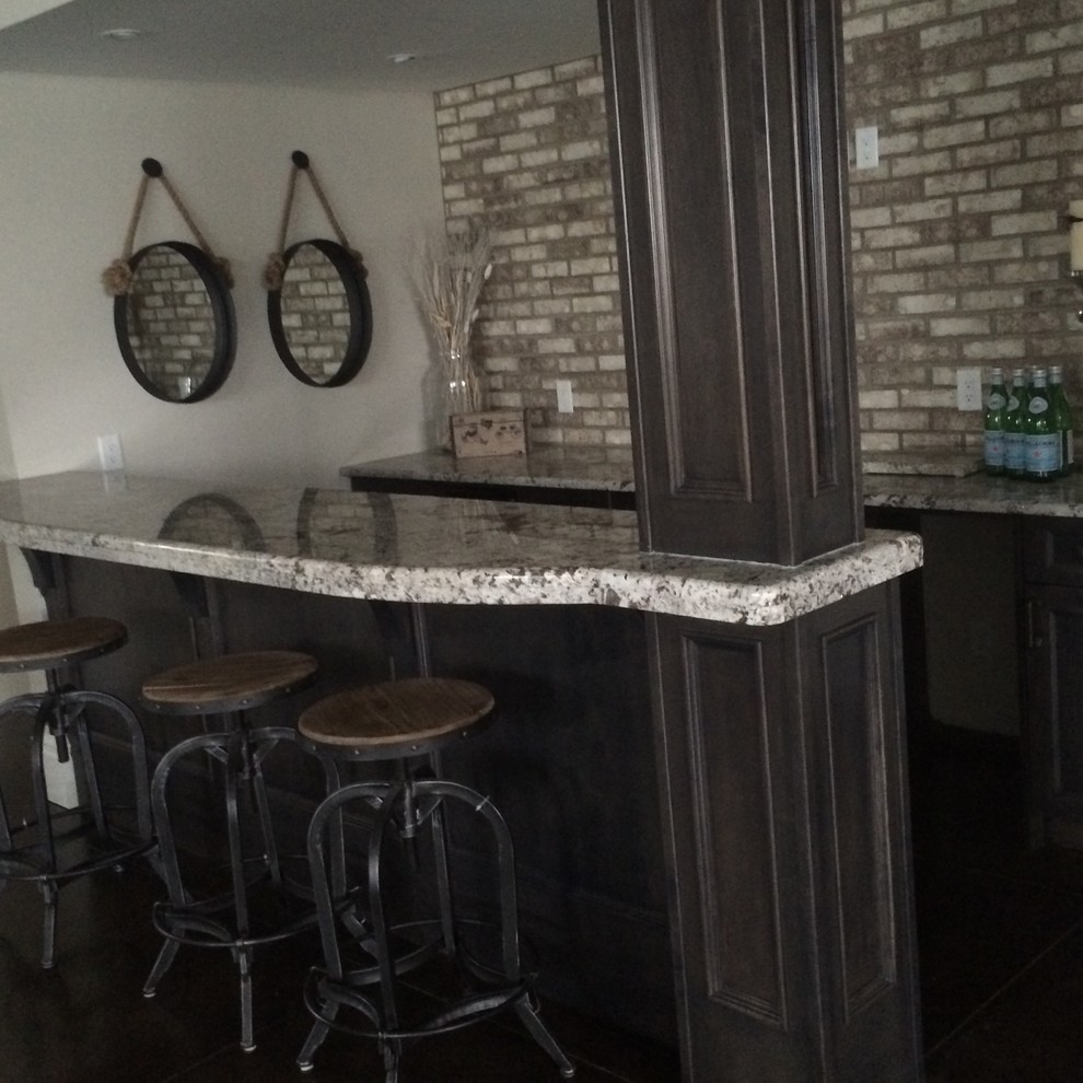 Contemporary galley wet bar in Calgary with an undermount sink, recessed-panel cabinets, dark wood cabinets, granite benchtops, multi-coloured splashback and stone tile splashback.