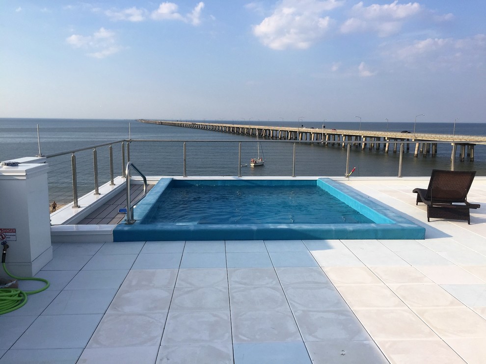 Photo of a small beach style rooftop custom-shaped natural pool in Other.