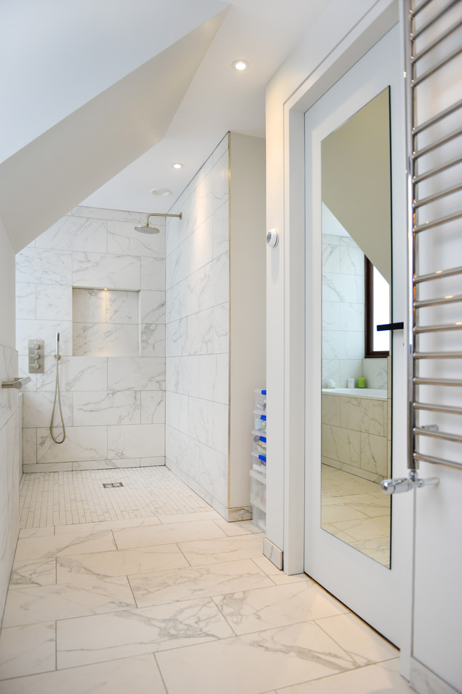 Mid-sized contemporary bathroom in Sussex with a drop-in tub, an open shower, a one-piece toilet, white tile, cement tile, white walls, porcelain floors and a drop-in sink.