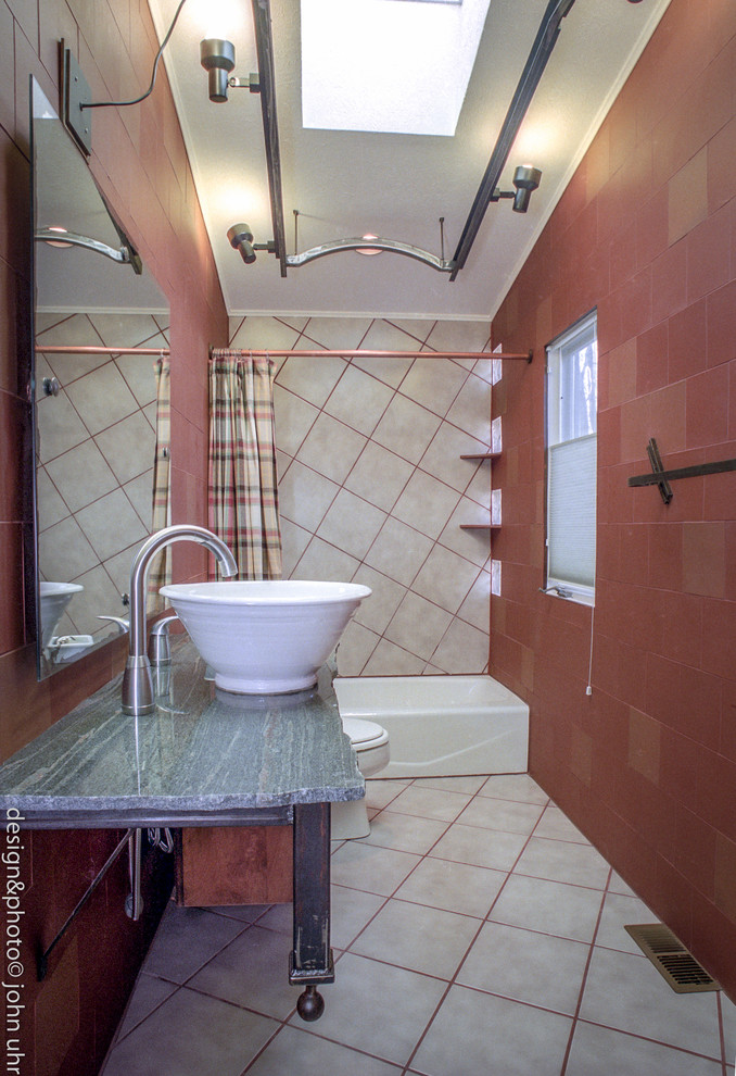 Inspiration for a large eclectic master bathroom in Denver with glass-front cabinets, black cabinets, a drop-in tub, a shower/bathtub combo, a one-piece toilet, red tile, porcelain tile, red walls, porcelain floors and a vessel sink.