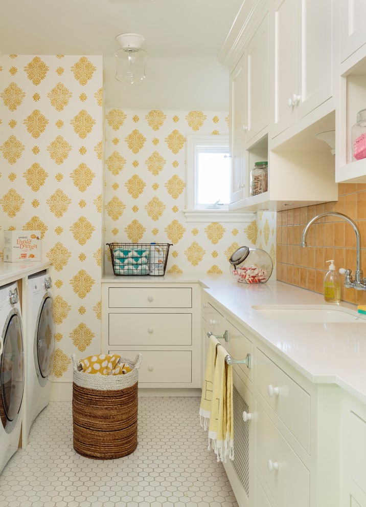 This is an example of a large transitional u-shaped dedicated laundry room in Los Angeles with an undermount sink, shaker cabinets, white cabinets, quartz benchtops, yellow walls, porcelain floors, a side-by-side washer and dryer, white floor and white benchtop.