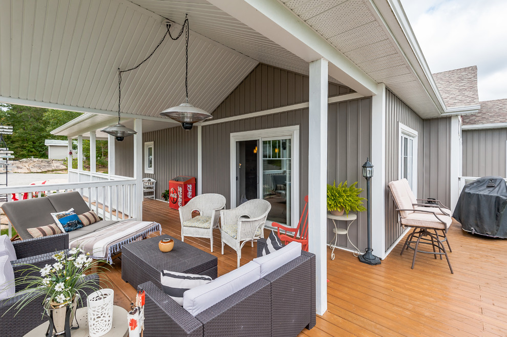 Deck - mid-sized transitional backyard deck idea with a roof extension