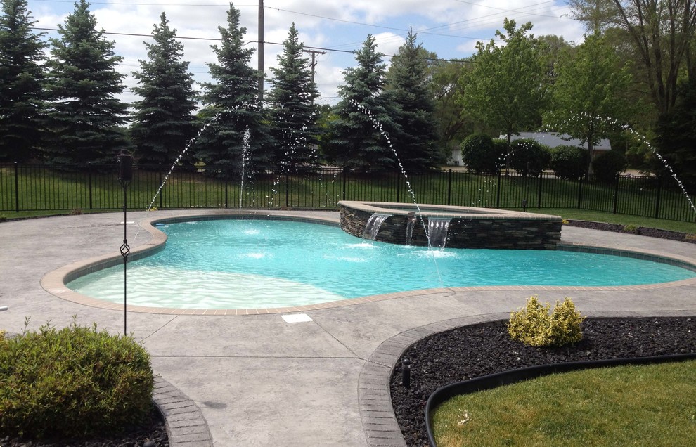 Inspiration for a mid-sized transitional backyard concrete and custom-shaped hot tub remodel in Detroit