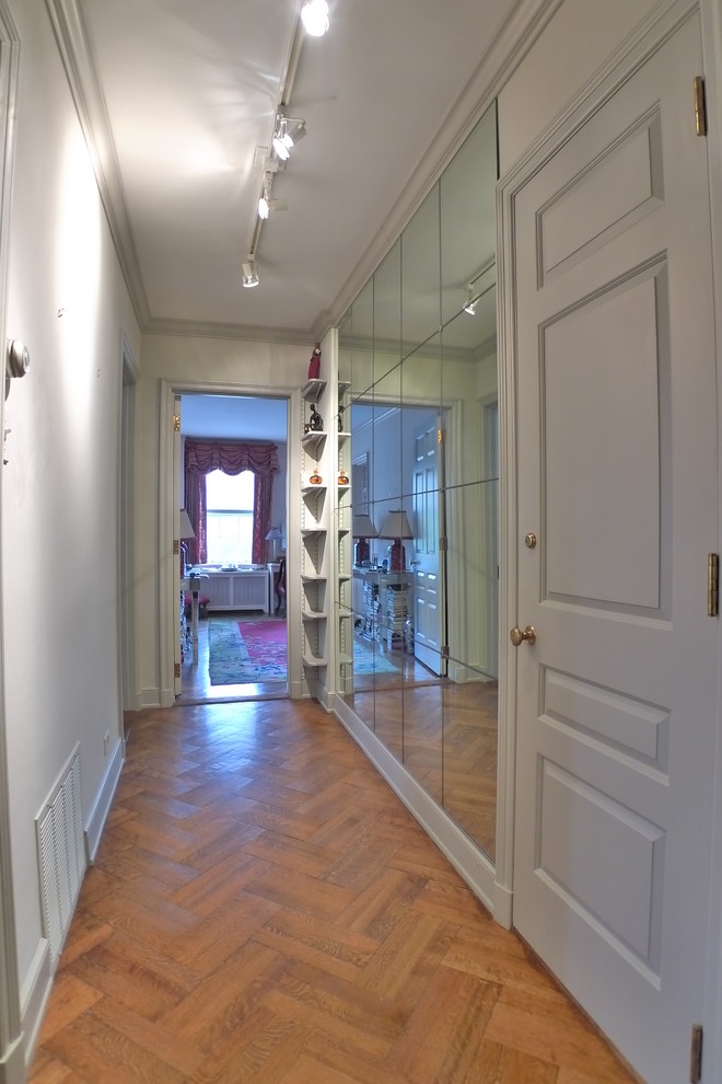 Inspiration for a mid-sized traditional hallway in Other with grey walls, medium hardwood floors and brown floor.