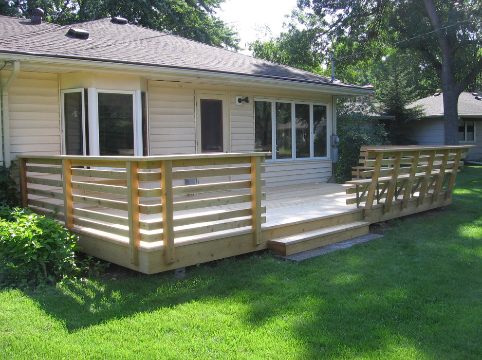 Example of a mid-sized classic backyard patio design in Minneapolis with decking and no cover